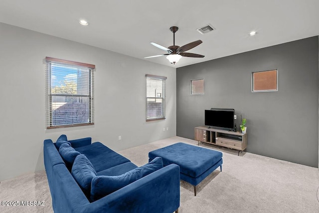 carpeted living room with plenty of natural light and ceiling fan