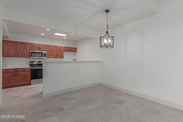 kitchen with hanging light fixtures and appliances with stainless steel finishes