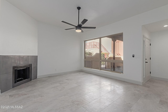 unfurnished living room with a fireplace and ceiling fan