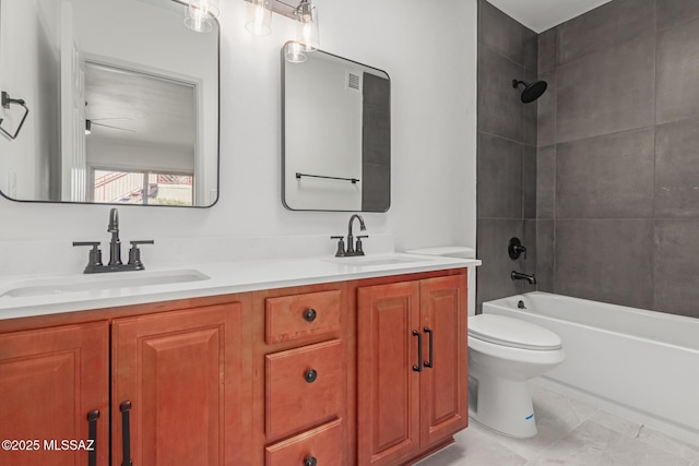 full bathroom with vanity, toilet, and tiled shower / bath combo