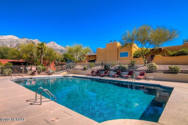 view of swimming pool featuring a mountain view and a patio