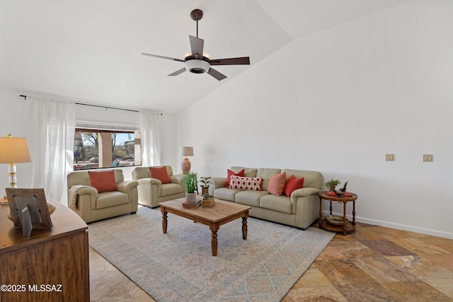 living room featuring high vaulted ceiling, stone finish flooring, a ceiling fan, and baseboards