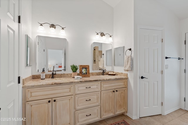 full bath featuring double vanity, a sink, and tile patterned floors