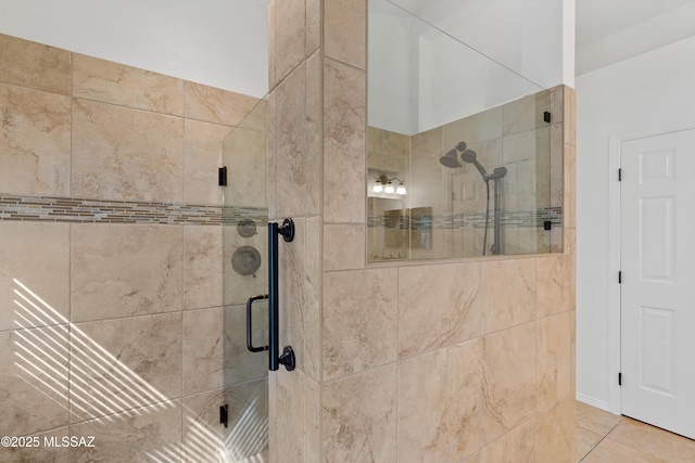 full bathroom featuring a stall shower and tile patterned flooring