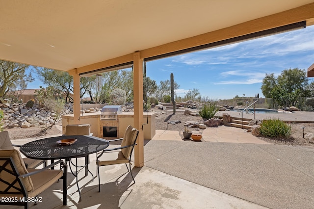 view of patio / terrace with area for grilling, an outdoor kitchen, a fenced backyard, and a fenced in pool