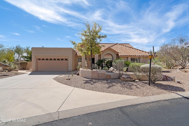 view of front of house featuring driveway, an attached garage, a tile roof, and stucco siding