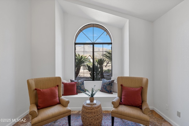 living area featuring baseboards