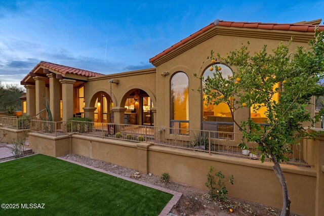 rear view of house featuring a patio area and a lawn