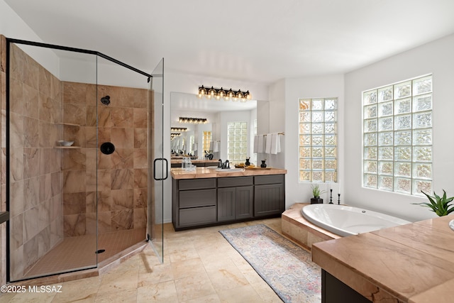 bathroom featuring vanity and separate shower and tub