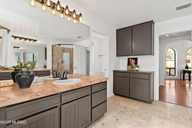 bathroom featuring vanity and an enclosed shower