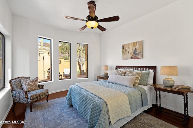 bedroom featuring dark hardwood / wood-style floors and ceiling fan