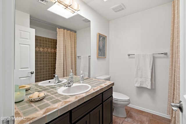 bathroom with vanity, tile patterned floors, and toilet