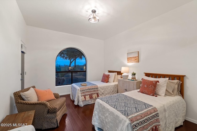 bedroom with dark hardwood / wood-style flooring