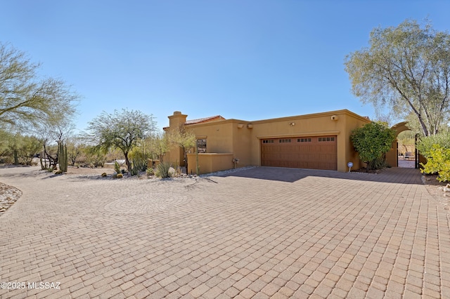 adobe home featuring a garage