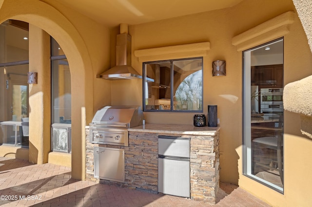 view of patio featuring area for grilling and a grill