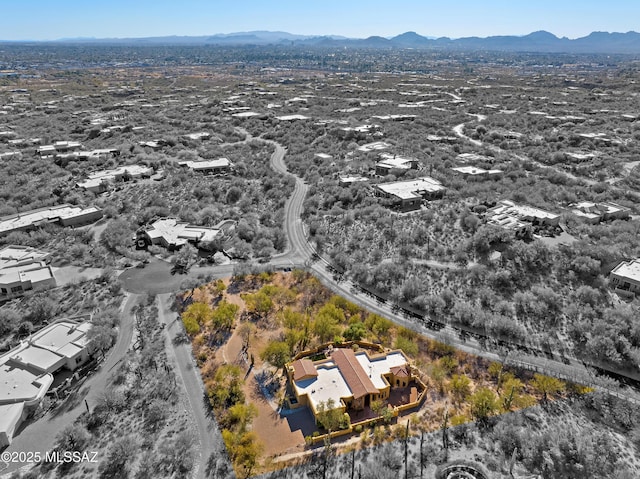 birds eye view of property with a mountain view