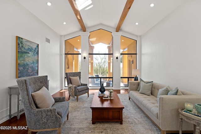 living room with hardwood / wood-style flooring, ornate columns, and lofted ceiling with beams