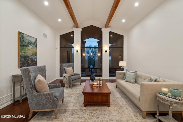 living room featuring light hardwood / wood-style floors, vaulted ceiling with beams, and ornate columns