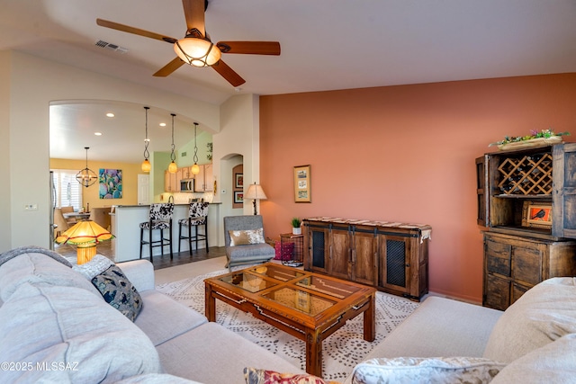 living room with ceiling fan and lofted ceiling