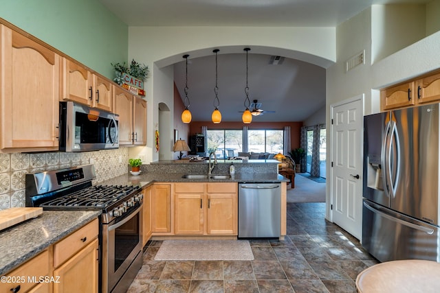 kitchen with decorative light fixtures, sink, decorative backsplash, kitchen peninsula, and stainless steel appliances