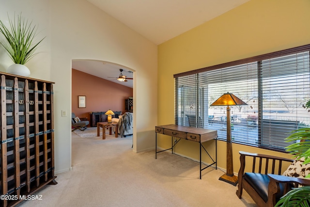 carpeted office featuring ceiling fan and high vaulted ceiling