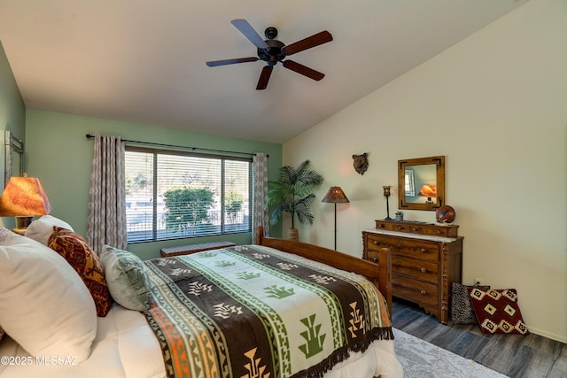 bedroom with vaulted ceiling, ceiling fan, and dark hardwood / wood-style flooring