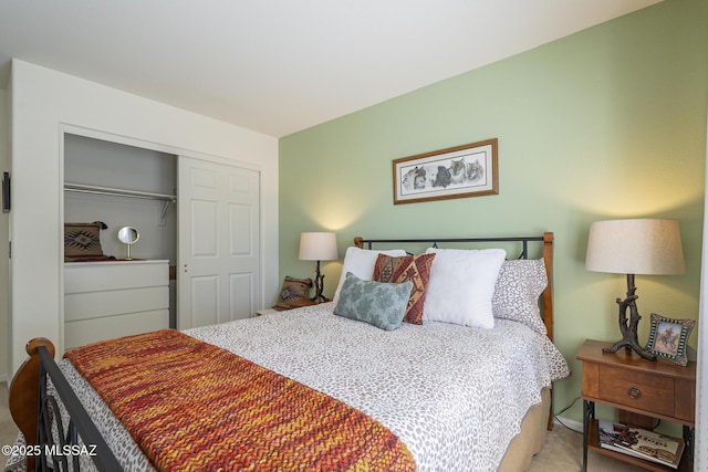 bedroom featuring light carpet and a closet