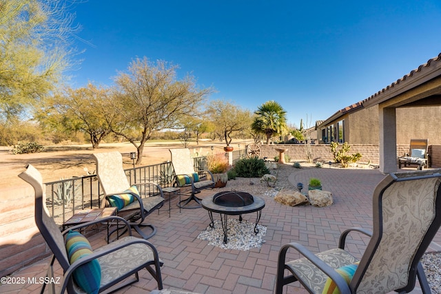 view of patio with a fire pit