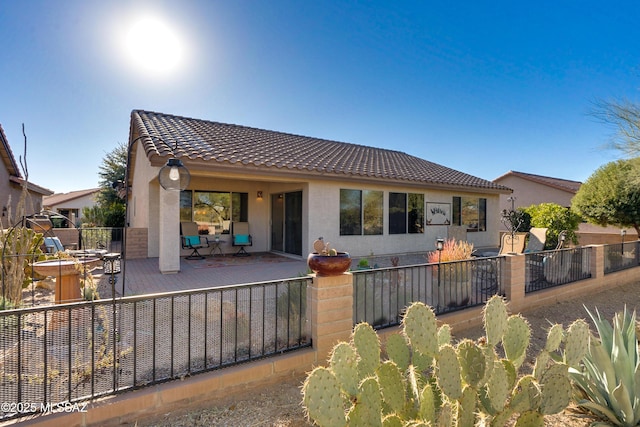 rear view of house featuring a patio