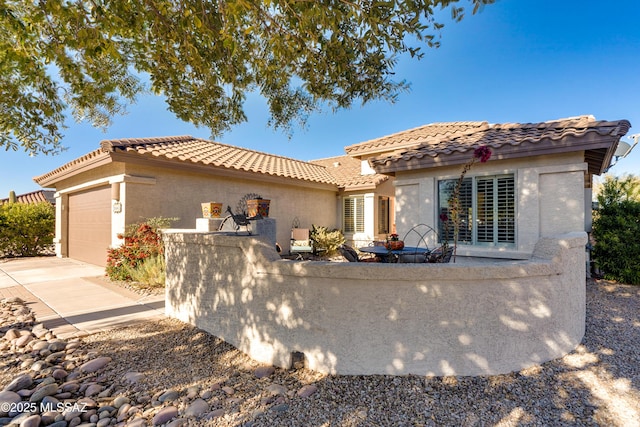 mediterranean / spanish home featuring a garage