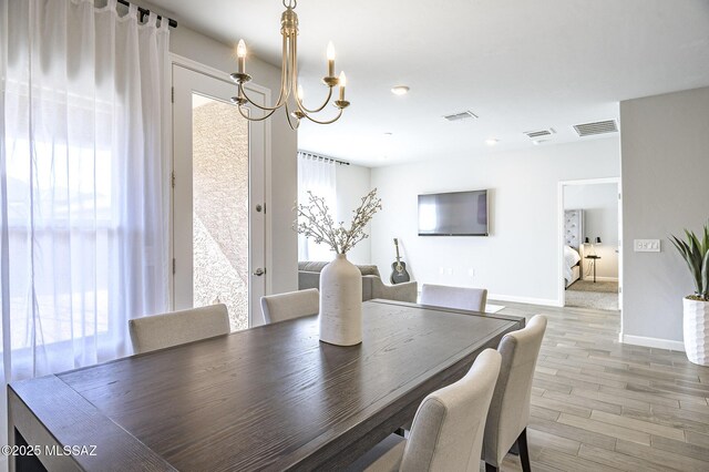 10139 N Sand Sage Trl, Marana, AZ 85653 - dining space with a notable chandelier, light hardwood / wood-style flooring, and a wealth of natural light
