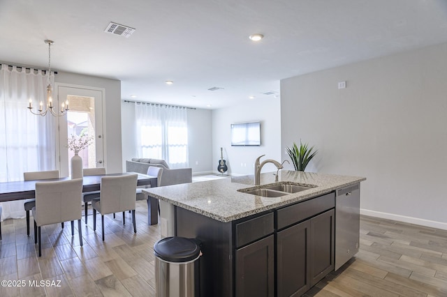 10139 N Sand Sage Trl, Marana, AZ 85653 - kitchen featuring sink, stainless steel dishwasher, pendant lighting, light stone countertops, and a kitchen island with sink