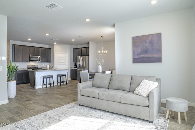 10139 N Sand Sage Trl, Marana, AZ 85653 - living room with light wood-type flooring and an inviting chandelier