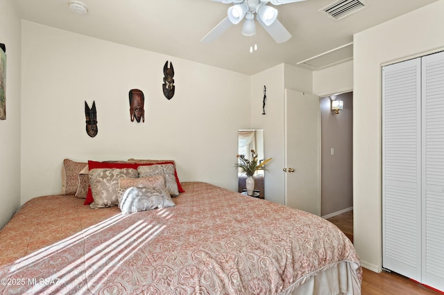 bedroom featuring ceiling fan, light hardwood / wood-style floors, and a closet