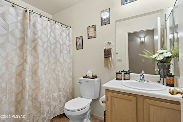 bathroom with vanity, toilet, and walk in shower