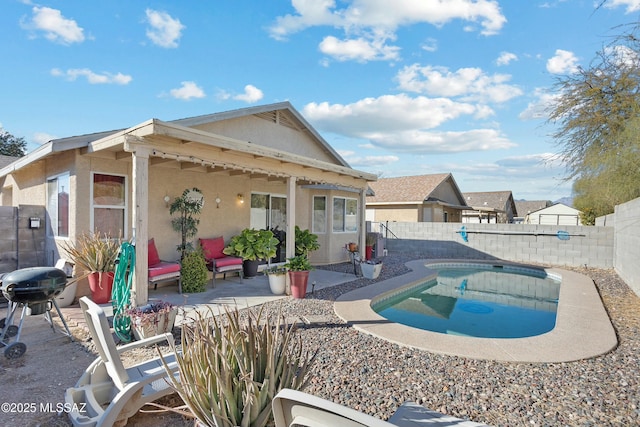 back of property featuring a fenced in pool and a patio area