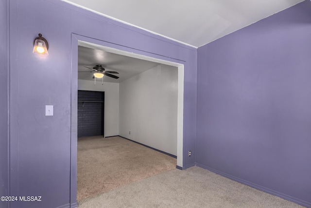 spare room with light colored carpet and ceiling fan