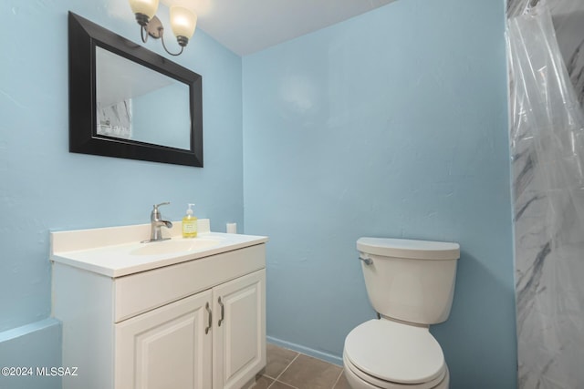 bathroom with vanity, tile patterned flooring, and toilet