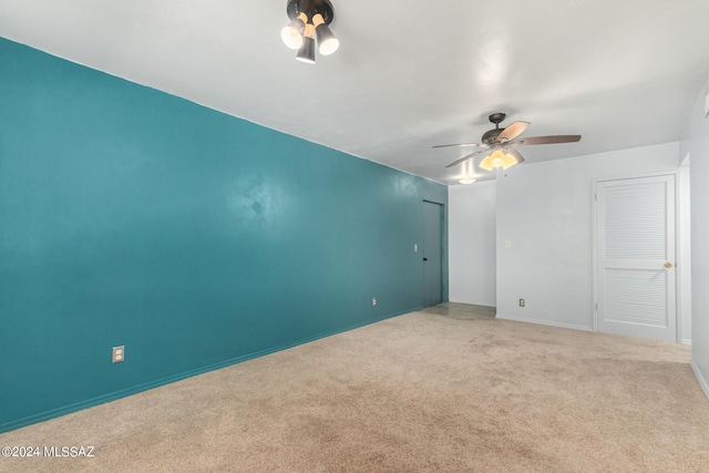 spare room with light colored carpet and ceiling fan