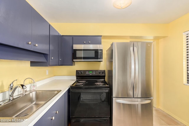 kitchen featuring stainless steel appliances, sink, blue cabinets, and light tile patterned floors