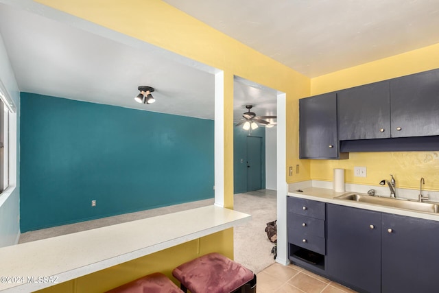 kitchen with ceiling fan, sink, and light tile patterned floors