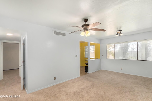 carpeted spare room with ceiling fan