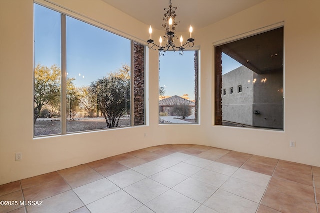 unfurnished dining area with an inviting chandelier and light tile patterned floors