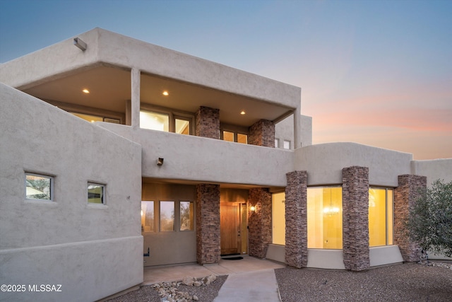 view of front of home featuring a balcony