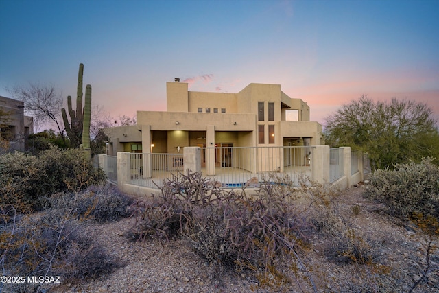 view of back house at dusk