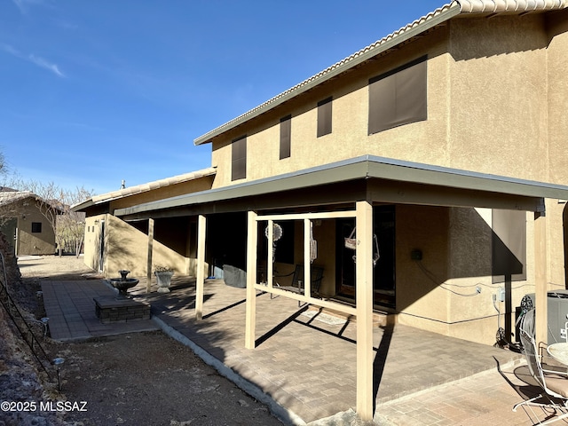 back of property with a patio area