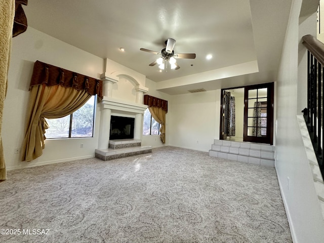 unfurnished living room with ceiling fan and carpet flooring