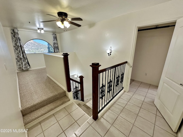 stairs with ceiling fan and tile patterned floors