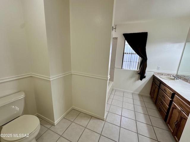 bathroom with vanity, toilet, and tile patterned flooring