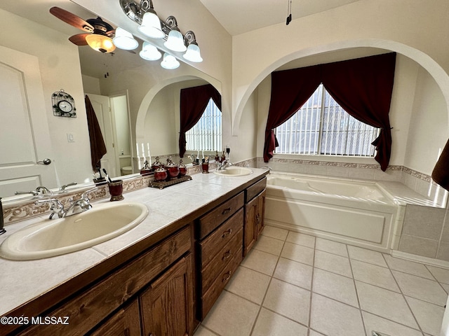 bathroom featuring tile patterned flooring, vanity, a washtub, and ceiling fan